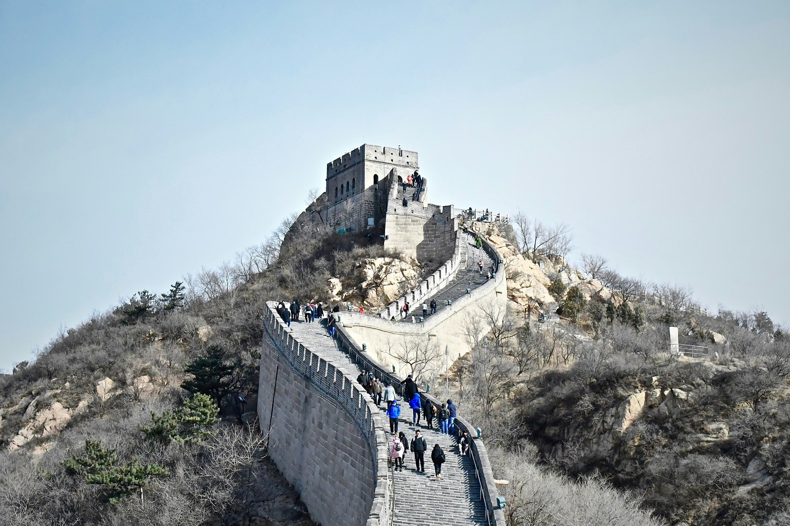 Distant full-body travelers in a wide landscape scene